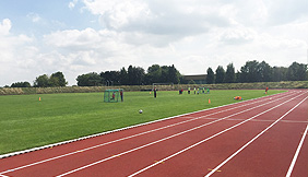 Artificial turf football field and plastic track